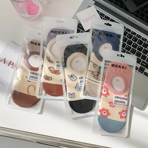 Detailed view of colorful cartoon jacquard no-show socks with individual packaging