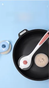 Detail of long-handle kitchen brush cleaning a pan with replaceable nano fiber heads