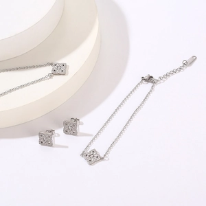 Macro shot of silver clover jewelry set with sparkling crystals for a minimalist look