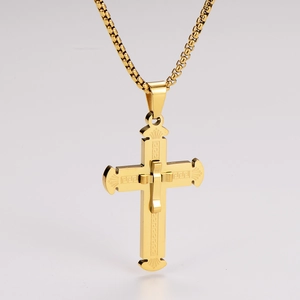 Detail of gold stainless steel cross pendant with intricate fretwork and box chain