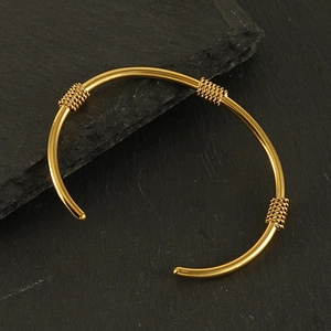 Classic gold stainless steel open bangle with triple twisted rope accents on black slate