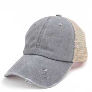 Detailed shot of distressed washed denim ponytail baseball cap with breathable mesh back