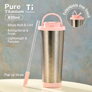 Macro view of 830ml titanium insulated tumbler with pink silicone straw and handle lid