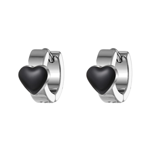 Detail of silver huggie hoop earrings with black heart inlay against a white background