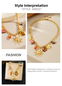 Detail of vintage gold sun and leopard print pendants on bohemian multi-element necklace