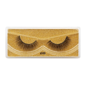 Detail of 3D faux mink eyelashes style #100 on a golden glitter background tray