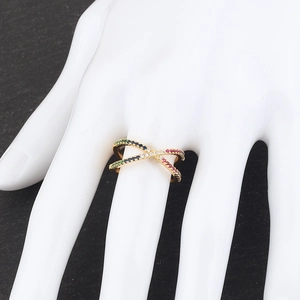 Detail of golden X-shaped crossover ring with vibrant multicolored zircon stones