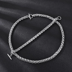 Minimalist silver stainless steel wheat chain necklace with classic OT buckle on black background