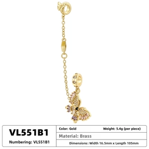 Detail of gold butterfly pendant safety chain with purple cubic zirconia and brass specs