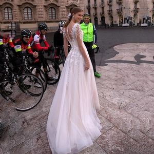 Elegant white lace deep V-neck wedding dress with long tulle train and back buttons