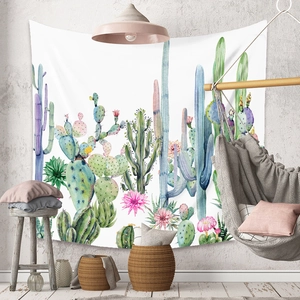 Detail of bohemian cactus tapestry in watercolor style hanging in a modern living room