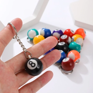 Close-up of colorful number 8 billiard ball resin keychains with polished metal rings
