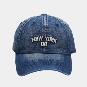 Macro detail of NEW YORK 08 embroidery on washed denim baseball cap with white 3D stitching