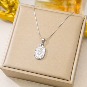 Elegant silver tulip flower embossed oval pendant necklace on a gold gift box display