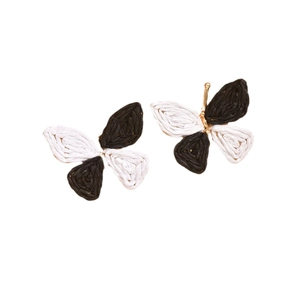 Handwoven raffia butterfly earrings in black and white bohemian style on white background