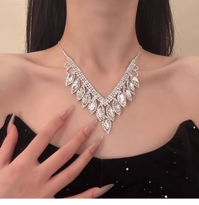 Close-up of elegant V-shaped diamond necklace with marquise and round stones on model