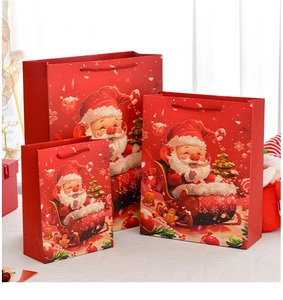 Three sizes of red Santa Claus gift bags with woven handles and festive illustrations