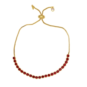 Detail of adjustable gold bracelet featuring vibrant red cubic zirconia in claw settings