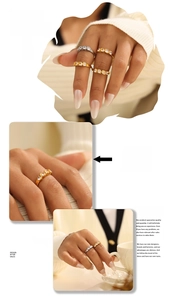 Detail of gold and silver wave rings with zircon stones on a model holding coffee