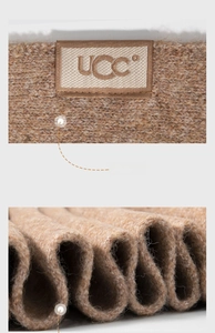 Close-up detail of a brown knitted wool blend scarf showing the brand logo label