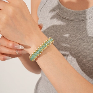 Close-up of vintage mint green and pearl beaded bracelet worn on a female wrist