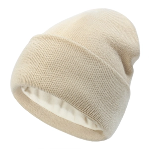 Detail of oatmeal knit beanie featuring a smooth satin lining for extra winter warmth