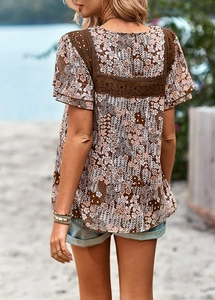 Close-up of floral print blouse featuring delicate dark brown lace patchwork details