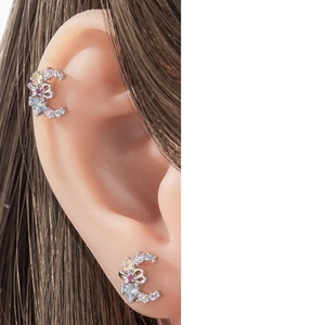 Macro shot of crescent-shaped ear cuff with colorful cubic zirconia and heart detail