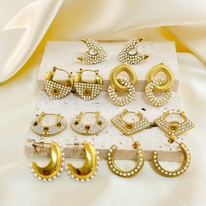 Vintage stainless steel 18k gold earrings set with micro-pave pearls on silk fabric