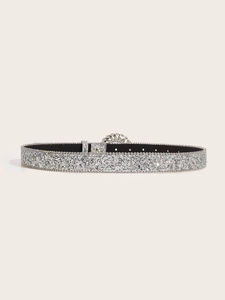 Detail of silver glitter belt featuring a luxury rhinestone-encrusted round buckle
