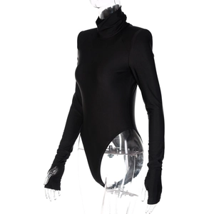 Detailed close-up of high neck bodysuit with thumb hole cuffs and elastic fabric texture