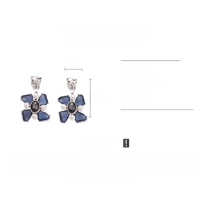 Detail view of vintage flower earrings with blue resin petals and grey gemstone center