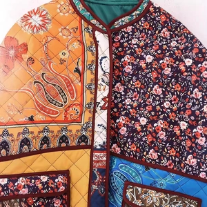 Quilted floral patchwork jacket with vibrant patterns and contrast brown piping detail