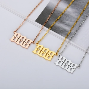 Three gothic 1998 number necklaces in rose gold, gold and silver finishes on textured paper