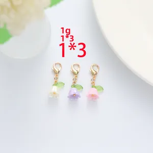 Three-piece set of lily of the valley pendants in white, purple, and pink with gold clasps