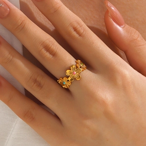 Chic gold flower stainless steel ring with colorful enamel inlay on female hand