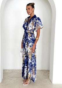 Detailed view of large floral pattern on a white long shirt dress with puff sleeves