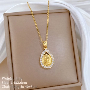 Close-up of a gold waterdrop pendant with portrait relief and sparkling pavé crystals