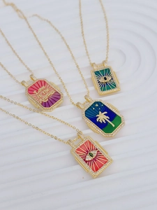 Detail of gold-plated tarot pendants with colorful enamel devil eye and zircon inlay