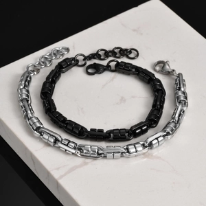Detail of silver and black stainless steel men's bracelets with lobster clasp
