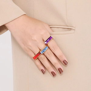 Luxurious gold stainless steel rings with colorful rectangular gemstones on hand