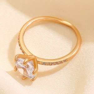 Anillo de moda en oro con gran circón cuadrado y engaste de seis garras sobre fondo seda