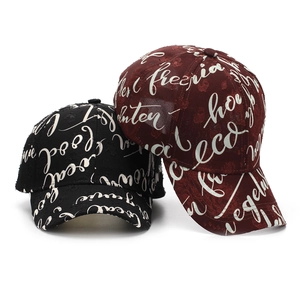 Distressed baseball caps in black and burgundy with all-over white script lettering