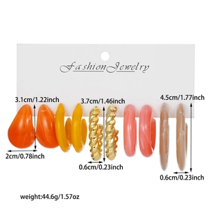 Detail view of 6-pair earring set featuring colorful resin hoops and golden metal spirals