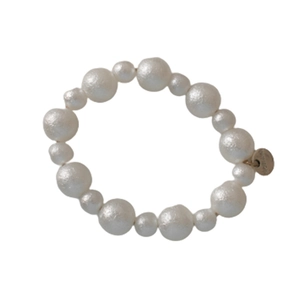 Elegant white matte pearl hair tie with AMOR metal charm on a clean white background