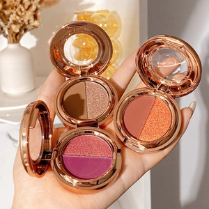 Three rose gold dual-color makeup palettes with matte and shimmer shades in hand