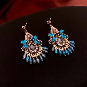 Vintage bohemian style chandelier drop earrings with blue crystals and gold finish