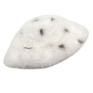 Detail of white faux fox fur bucket hat with thick plush texture and dark brown spots