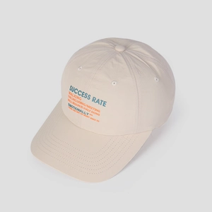 Detail view of beige nylon baseball cap featuring vintage letter print and breathable fabric