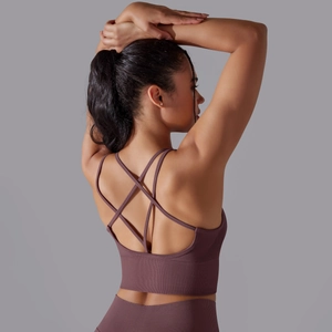 Detail of purple sports bra featuring cross-back straps and ribbed texture fabric
